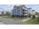 Three-story stilt house with multiple balconies, driveway, and blue exterior at 510 S Ocean Blvd., Surfside Beach, SC 29575
