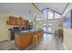 Well-lit kitchen featuring a kitchen island with stools, wooden cabinets, and modern appliances at 510 S Ocean Blvd., Surfside Beach, SC 29575