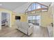 Bright living room featuring vaulted ceilings, large windows, and modern furnishings with access to balcony at 510 S Ocean Blvd., Surfside Beach, SC 29575