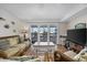 Inviting living room with cozy seating and sliding doors to a deck at 510 S Ocean Blvd., Surfside Beach, SC 29575