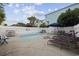 Backyard pool area with a white fence, lounge chairs, and a grill at 510 S Ocean Blvd., Surfside Beach, SC 29575