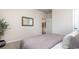 Cozy bedroom showcasing plush bedding, a decorative mirror, and an open doorway at 5163 Yellowstone Dr., Conway, SC 29526