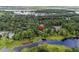 Aerial view of property nestled among lush trees, showcasing pond access in a serene neighborhood at 532 Medcalf Dr. Sw, Sunset Beach, NC 28468