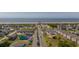 Aerial view of street with parking leading up to a pier and the beach at 532 Medcalf Dr. Sw, Sunset Beach, NC 28468