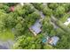 Aerial view showcasing a home with a spacious deck, pool, pond access and lush surroundings at 532 Medcalf Dr. Sw, Sunset Beach, NC 28468