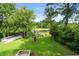 Spacious backyard featuring a fire pit, storage shed, palm trees, and access to a peaceful pond at 532 Medcalf Dr. Sw, Sunset Beach, NC 28468