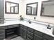 Full bathroom with dual sinks, granite countertop, and framed mirrors at 532 Medcalf Dr. Sw, Sunset Beach, NC 28468
