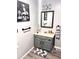 A renovated bathroom features a modern vanity, framed mirror, modern lighting, and stylish decor at 532 Medcalf Dr. Sw, Sunset Beach, NC 28468