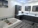 Bathroom boasts soaking tub, vanity with dual sinks, and modern fixtures at 532 Medcalf Dr. Sw, Sunset Beach, NC 28468