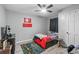 A cozy bedroom offers wood floors, ceiling fan, and a window with dark curtain panels at 532 Medcalf Dr. Sw, Sunset Beach, NC 28468