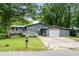 Charming single Gathering home with front porch, garage, blue door, and a well-maintained lawn at 532 Medcalf Dr. Sw, Sunset Beach, NC 28468