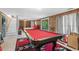 Spacious game room features a billiard table and walkout to the backyard at 532 Medcalf Dr. Sw, Sunset Beach, NC 28468