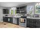 Modern kitchen boasts black cabinets, stainless steel appliances, and ample counter space at 532 Medcalf Dr. Sw, Sunset Beach, NC 28468
