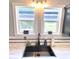 Close-up of a kitchen sink with modern fixtures and a window providing natural light at 532 Medcalf Dr. Sw, Sunset Beach, NC 28468