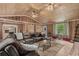 Spacious living area with wood-paneled walls, featuring a large sectional couch and bright natural light at 532 Medcalf Dr. Sw, Sunset Beach, NC 28468