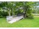 Charming shed with a wooden walkway, surrounded by lush greenery near the pond at 532 Medcalf Dr. Sw, Sunset Beach, NC 28468