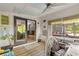 Cozy sunroom with ceiling fan, natural light, and access to back deck at 532 Medcalf Dr. Sw, Sunset Beach, NC 28468