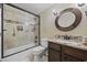 This bathroom offers a shower and tub combination, granite counters, and decorative tile at 5825 Peachtree Rd., Myrtle Beach, SC 29588