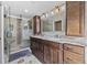 Luxurious bathroom featuring double sinks, a large mirror, and a glass-enclosed shower for a spa-like experience at 5825 Peachtree Rd., Myrtle Beach, SC 29588