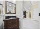 Charming powder room featuring a dark wood vanity and a decorative mirror adding a touch of elegance at 5825 Peachtree Rd., Myrtle Beach, SC 29588