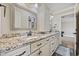 Double vanity in a bathroom with granite countertops and white cabinets, offering ample storage at 5825 Peachtree Rd., Myrtle Beach, SC 29588