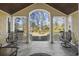 Relaxing front porch with tiled flooring, comfortable seating, and views of the landscaped front yard at 5825 Peachtree Rd., Myrtle Beach, SC 29588