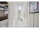 This neutral hallway is well-lit with tile floors and leads to the main bedroom at 5825 Peachtree Rd., Myrtle Beach, SC 29588
