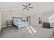 This main bedroom has high ceilings with a ceiling fan and an en suite bathroom at 5825 Peachtree Rd., Myrtle Beach, SC 29588