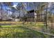 Backyard playground with wooden play structure and swings, perfect for to enjoy outdoor fun at 5825 Peachtree Rd., Myrtle Beach, SC 29588
