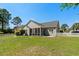Expansive backyard featuring a well-maintained lawn, fenced perimeter, and serene surroundings at 615 Woodbine Ct., Myrtle Beach, SC 29579