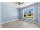 Empty bedroom featuring neutral walls, wood-look flooring, and a large window at 615 Woodbine Ct., Myrtle Beach, SC 29579