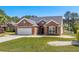 Charming brick home featuring a well-maintained lawn and attached two-car garage at 615 Woodbine Ct., Myrtle Beach, SC 29579