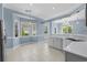 Bright kitchen with white cabinetry, stainless steel sink, and a view of the dining area at 615 Woodbine Ct., Myrtle Beach, SC 29579