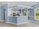 Modern kitchen with white cabinets, breakfast bar, and stainless steel appliances at 615 Woodbine Ct., Myrtle Beach, SC 29579