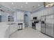 Modern kitchen featuring white cabinets, stainless steel appliances, and tiled floors at 615 Woodbine Ct., Myrtle Beach, SC 29579