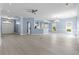 Open-concept living space with light blue walls, light floors, and a view to the kitchen at 615 Woodbine Ct., Myrtle Beach, SC 29579