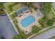 Aerial view of a community pool area with ample seating and lush landscaping at 615 Woodbine Ct., Myrtle Beach, SC 29579