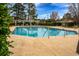 Corner view of a community pool with handrails and a pergola in the background at 615 Woodbine Ct., Myrtle Beach, SC 29579