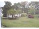 Scenic view of the backyard with green grass, trees, and bushes at 6204 Sweetwater Blvd. # 6204, Murrells Inlet, SC 29576
