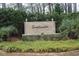 Elegant community entrance sign with decorative landscaping, lighting, and a stacked stone base at 6204 Sweetwater Blvd. # 6204, Murrells Inlet, SC 29576