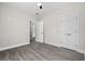 This bedroom has gray flooring, natural light, neutral paint, and two white doors at 627 Bonaventure Dr. # 101, Myrtle Beach, SC 29577