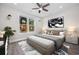 Bright main bedroom featuring a ceiling fan, large window, and stylish contemporary decor at 627 Bonaventure Dr. # 101, Myrtle Beach, SC 29577
