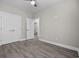 Spacious bedroom with hardwood floors, ceiling fan, and ensuite bathroom for modern comfort at 627 Bonaventure Dr. # 103, Myrtle Beach, SC 29577