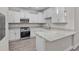 Bright kitchen with granite countertops, stainless steel appliances, and white cabinetry at 627 Bonaventure Dr. # 103, Myrtle Beach, SC 29577