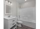 A bright bathroom featuring a shower over tub, and a white vanity with storage at 627 Bonaventure Dr. # 201, Myrtle Beach, SC 29577