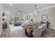 Staged living room with wood flooring, dining table, and comfortable seating area at 627 Bonaventure Dr. # 201, Myrtle Beach, SC 29577