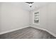 This airy bedroom has a large window and is finished with stylish gray wood flooring at 627 Bonaventure Dr. # 203, Myrtle Beach, SC 29577