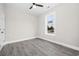 This airy bedroom with a large window and gray wood flooring provides a soothing space at 627 Bonaventure Dr. # 203, Myrtle Beach, SC 29577