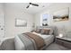 Stylish bedroom with plush bed, modern decor, and ample natural light from a large window at 627 Bonaventure Dr. # 203, Myrtle Beach, SC 29577