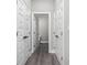 Hallway view featuring several closet doors and a view into an adjacent bathroom at 627 Bonaventure Dr. # 203, Myrtle Beach, SC 29577